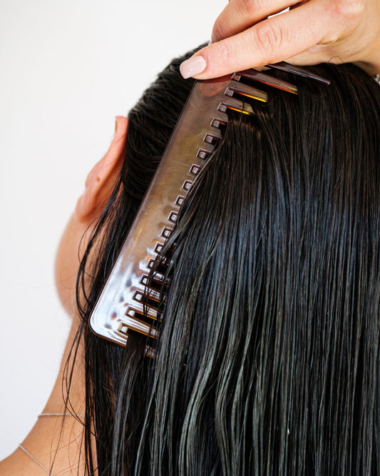 Woman combing hair