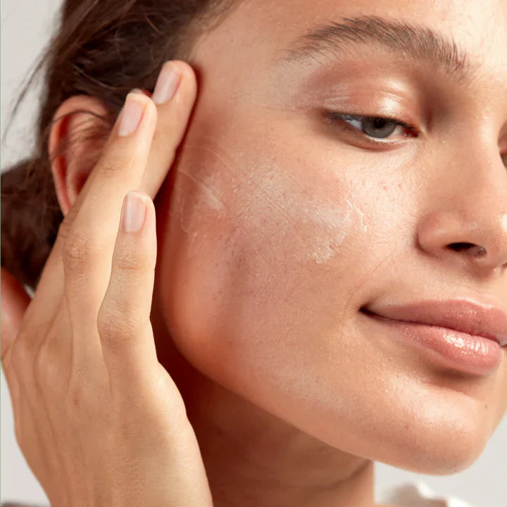 Woman applying skincare