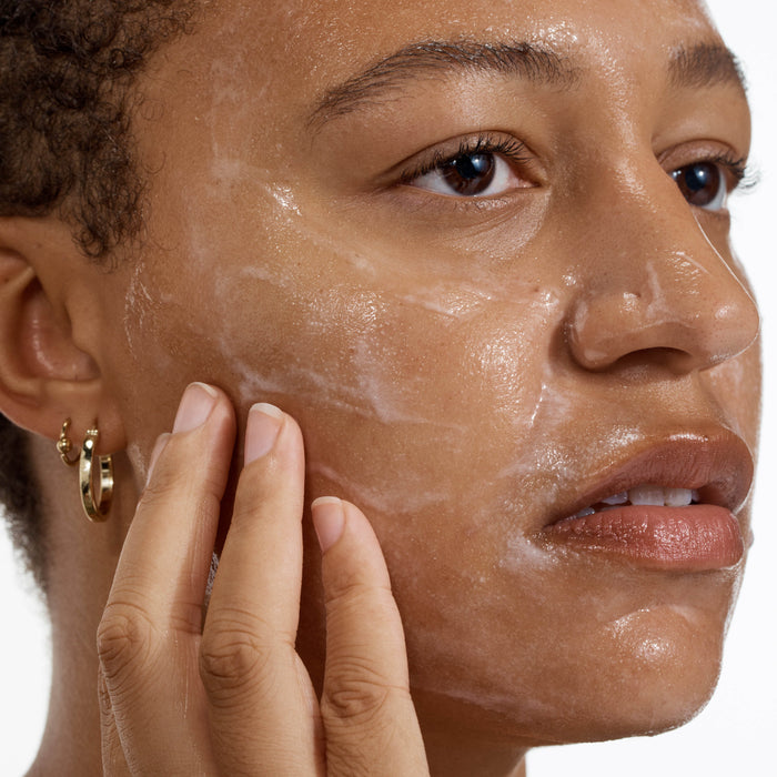 Person applying skincare 