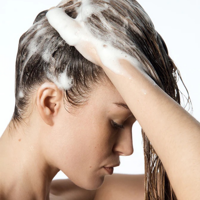Woman massaging shampoo into her scalp