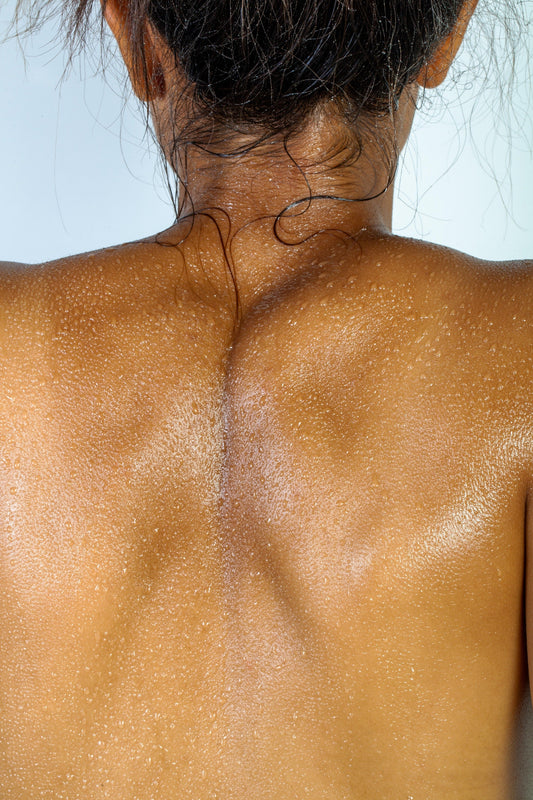 Women's back with droplets of water